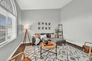 Living room featuring lofted ceiling and wood-type flooring