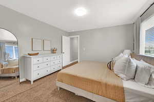 Bedroom featuring carpet floors and a textured ceiling