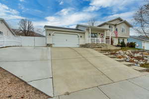 Split level home with a garage and covered porch