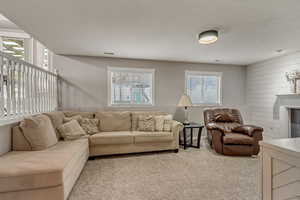 Living room with light carpet and wood walls