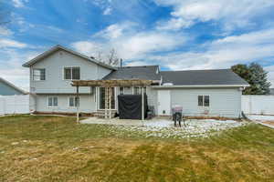 Rear view of house featuring a patio area and a lawn