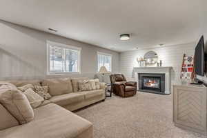 Living room with carpet floors and wood walls