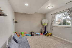 Rec room with carpet and a textured ceiling