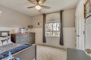 Bedroom featuring light colored carpet and ceiling fan