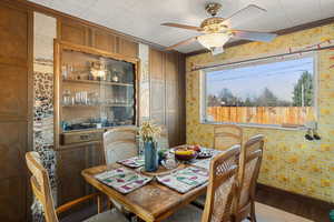 Dining room with ceiling fan, wood-type flooring, and crown molding