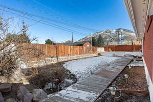 Yard covered in snow with a mountain view