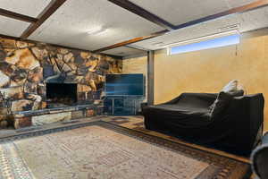 Living room featuring a fireplace and beam ceiling