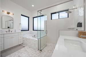 Bathroom featuring tile patterned flooring, plus walk in shower, and vanity