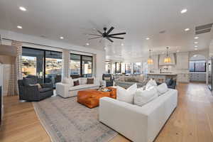 Living room featuring ceiling fan and light wood-type flooring