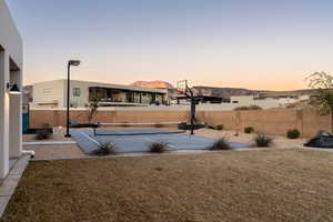 View of basketball court featuring a mountain view, a yard, and tennis court