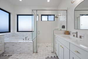 Bathroom with tile patterned floors, vanity, and shower with separate bathtub