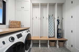 Laundry room featuring cabinets and separate washer and dryer