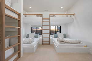 Bedroom featuring light colored carpet