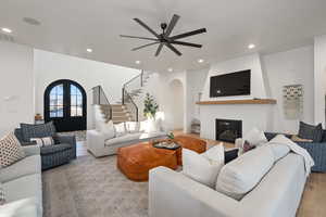 Living room with light hardwood / wood-style flooring, french doors, and ceiling fan