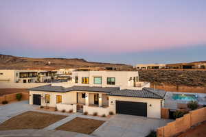 View of front of home with a garage and a mountain view