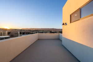 Balcony at dusk featuring a mountain view