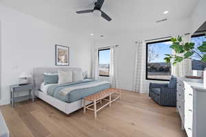 Bedroom with ceiling fan and light hardwood / wood-style flooring