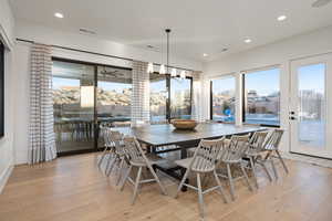 Dining area with an inviting chandelier and light wood-type flooring