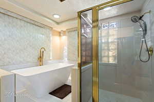 Bathroom with independent shower and bath and tile patterned flooring