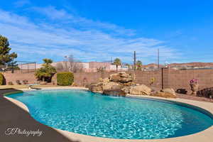 View of pool with pool water feature and a diving board