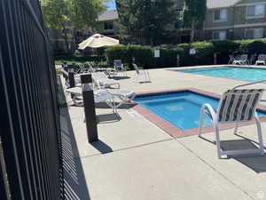 View of pool with a community hot tub and a patio area