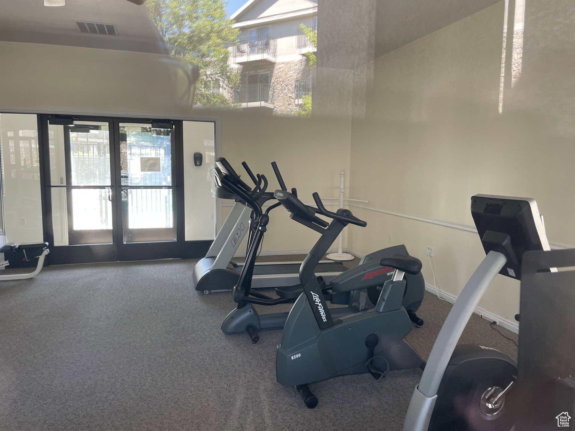 Workout area featuring french doors