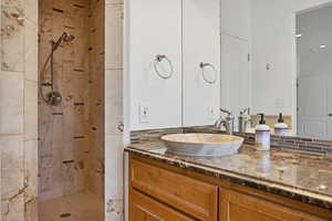 Bathroom featuring vanity and a tile shower