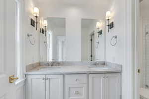 Full bathroom featuring a sink and double vanity
