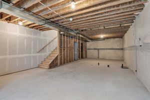 Unfinished basement featuring stairway
