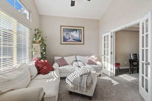 Sitting room just off of the entryway with double doors leading into a formal dining room.