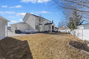 Rear view of property featuring a patio and a yard