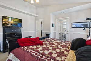 Primary bedroom showing door to the private balcony. The room has it's own bathroom with separate tub shower as well as a walk in closet.