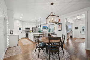 Dining room featuring sink, a chandelier, and light wood-type flooring