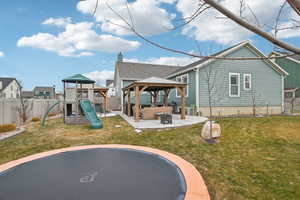 View of play area featuring a gazebo, an outdoor hangout area, a patio, and a lawn