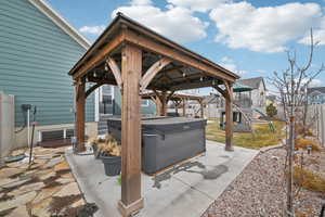 View of patio / terrace featuring a gazebo and a hot tub