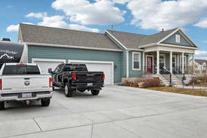 View of front of home with a garage and covered porch