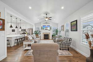 Living room featuring dark hardwood / wood-style flooring, a wealth of natural light, and ceiling fan