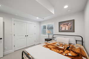 Carpeted bedroom featuring a closet