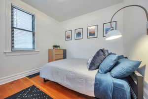 Bedroom with wood-type flooring