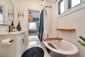 Bathroom with tile patterned flooring, vanity, and tub/shower