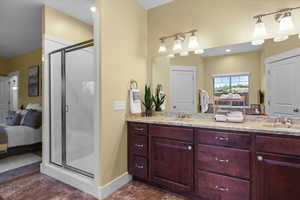 Bathroom with vanity and a shower with door