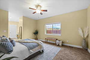 Carpeted bedroom with ceiling fan