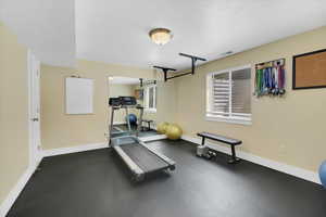 Exercise room with a textured ceiling