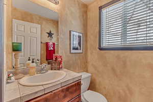 Bathroom featuring vanity and toilet