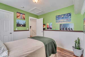 Bedroom featuring hardwood / wood-style floors and a textured ceiling