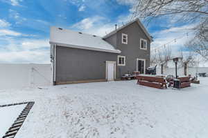 View of snow covered back of property