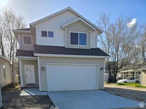 View of property with cooling unit and a garage