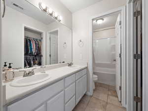 Full bathroom with vanity, toilet, and shower / tub combination