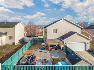 Back of property with a garage