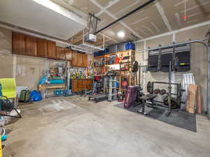 Garage with a garage door opener and a workshop area